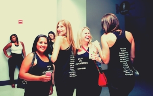 JT fans showing off the T-shirts they made, with a list of all the concerts they've been to together